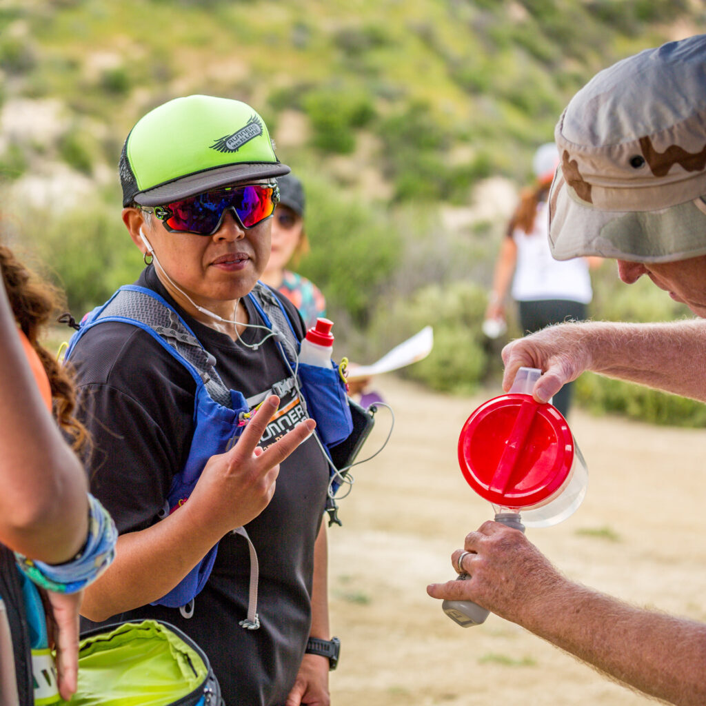 Volunteer filling bottle